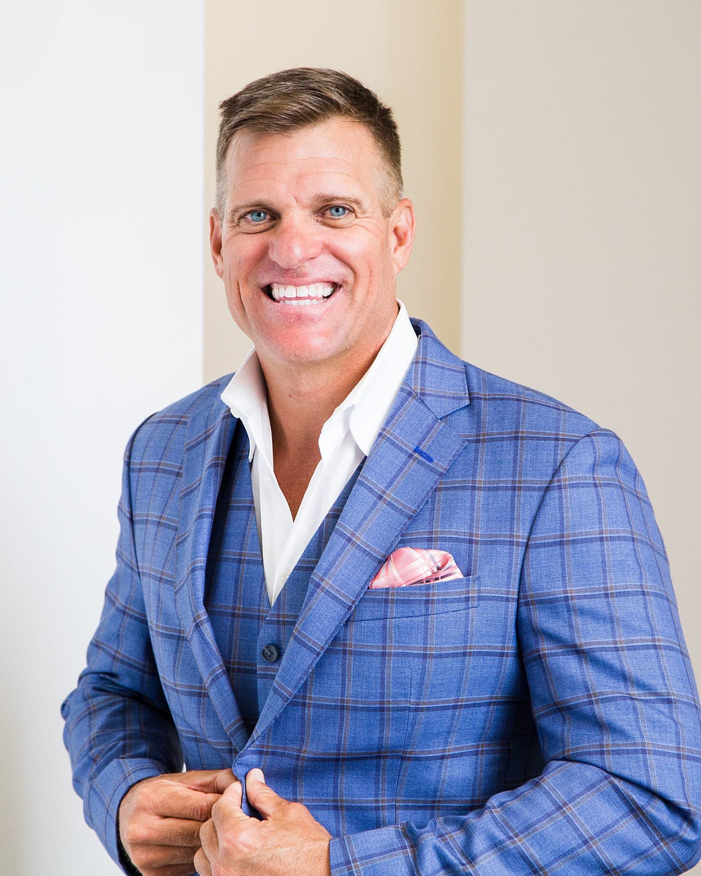 Dave VanHoose buttoning his suit jacket: suiting back up